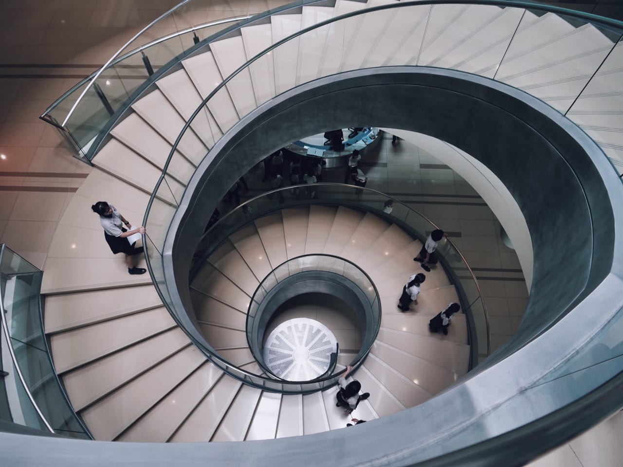 large spiral staircase with people walking up